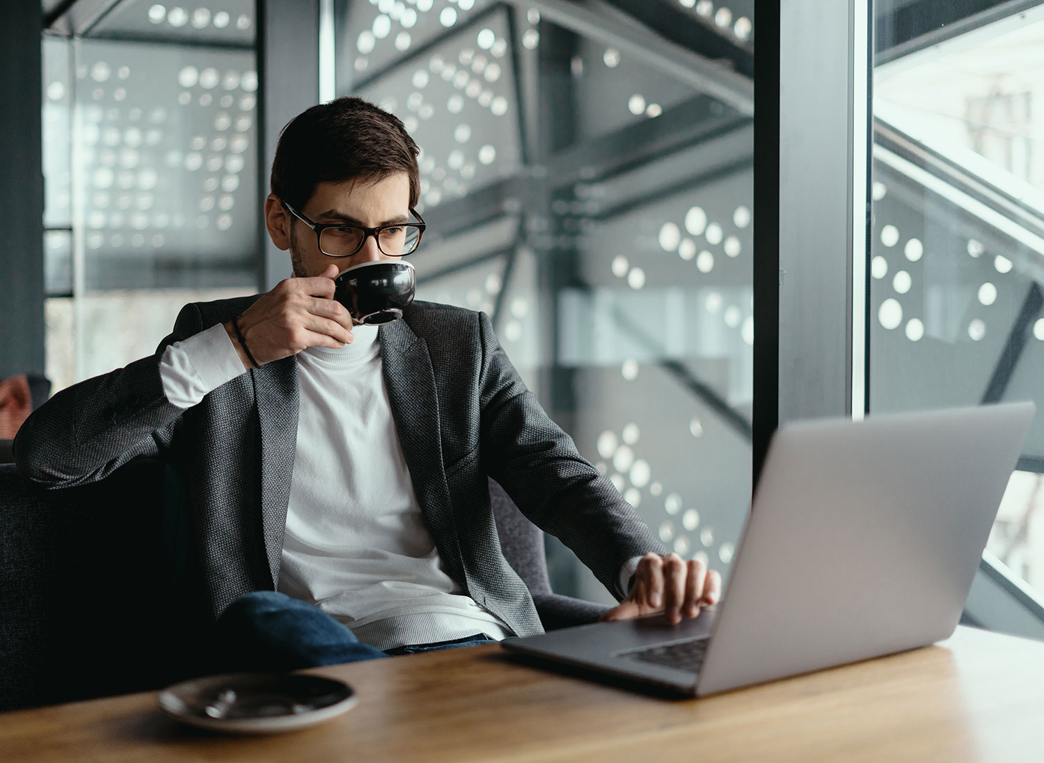 successful--man-working-laptop-while-drinking-coffee